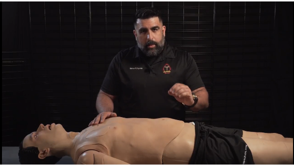 Founder demonstrating medical training technique with CPR mannequin